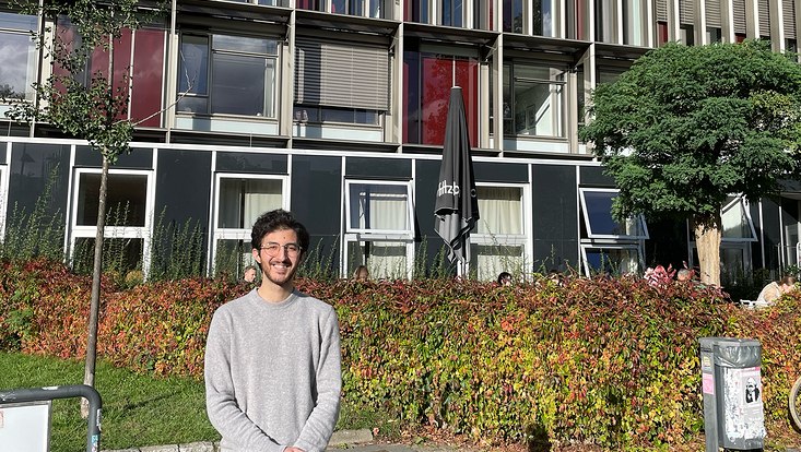 Bashar Almazrawi outside in front of the faculty building, smiling