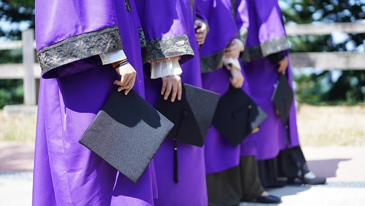 convocation-4119260-733x414 Vier Menschen mit Abschlussmappen in der Hand.