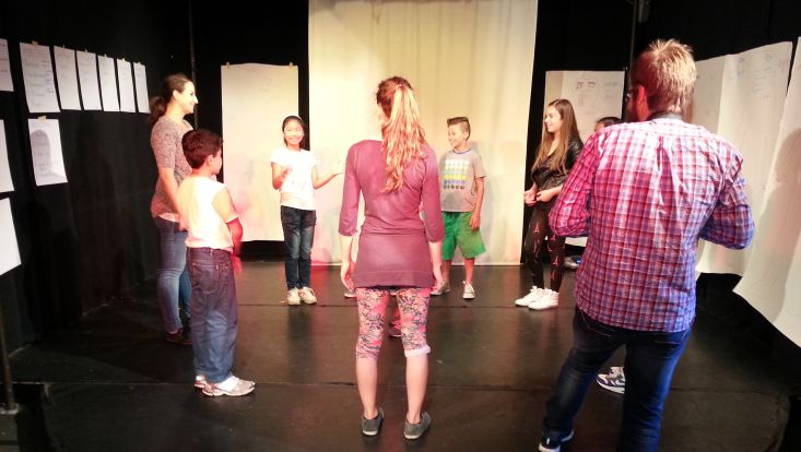 SchülerInnen stehen im Kreise als Teil einer theaterpädagogischen Permformance.