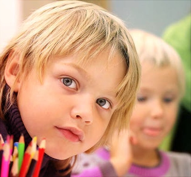 Boy in front sitting in classroom