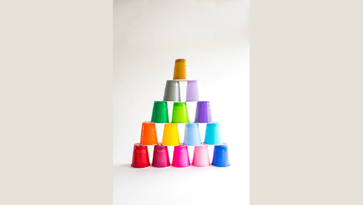 Darstellung der Zahl 15 durch 15 bunte Plastikbecher, die pyramidenförmig angeordnet sind.