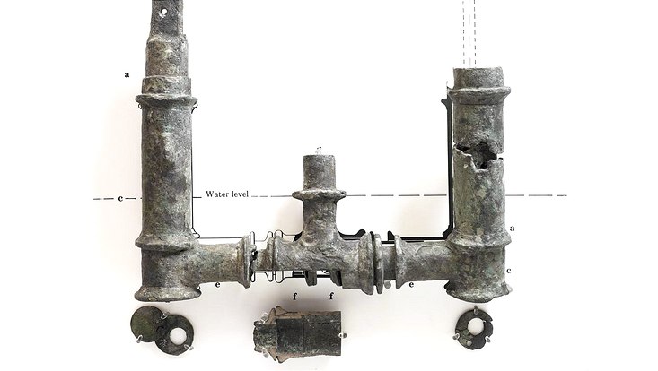Five fragments of a bronze double-action water-pump, including a nail