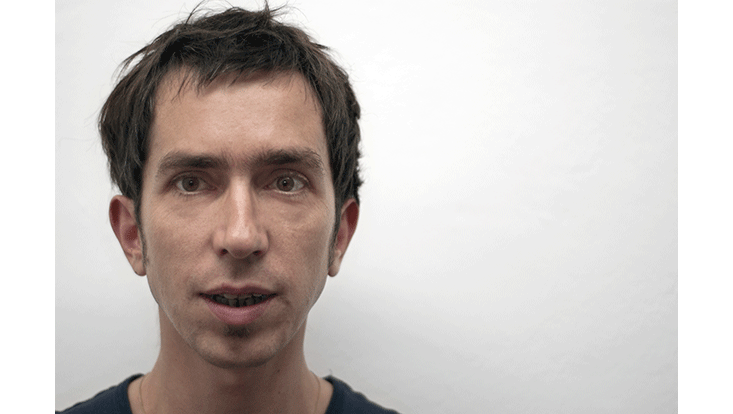 portrait of Wolfie Christl in front of white wall