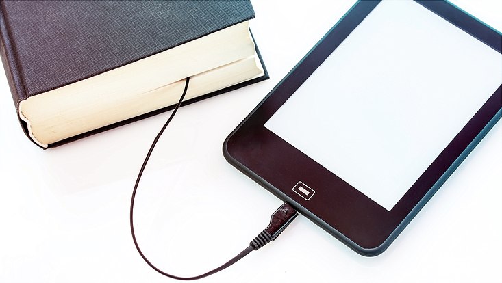 Buch und Tablet mit einem Kabel verbunden