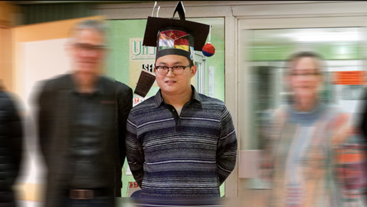 Yumeng Chen successfully defended his doctoral thesis. The picture shows Yumeng with his doctoral hat.