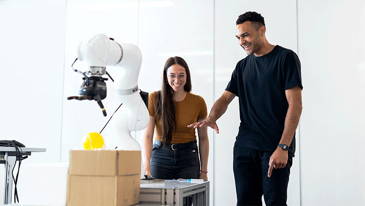 a female and a male engineer developing a robotic arm