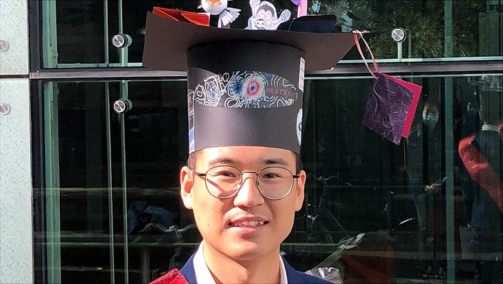 Qiyun Ma successfully defended his doctoral thesis. The picture shows Qiyun with her doctoral hat.