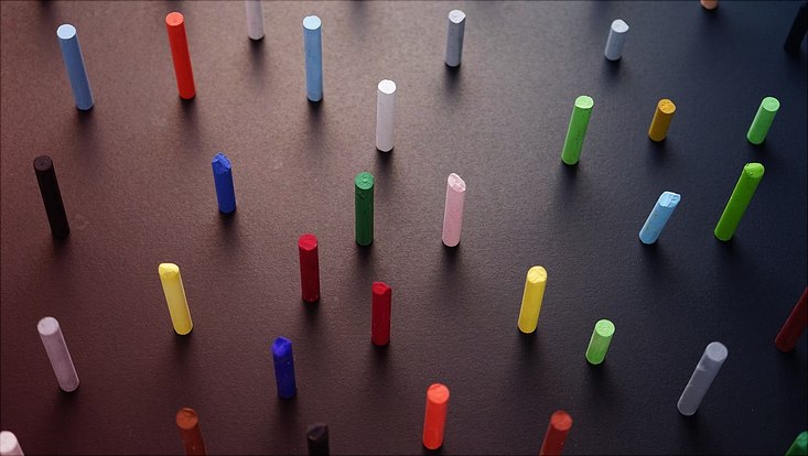 crayons in different colours standing on a flat surface