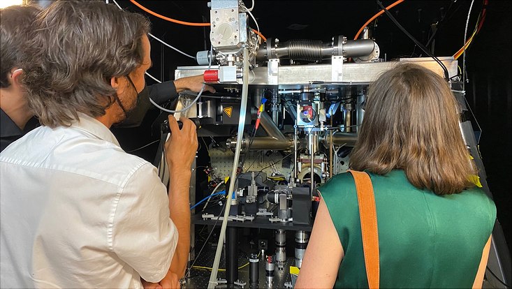 Mann und Frau sind von hinten zu sehen und gucken auf experimentelle Geräte