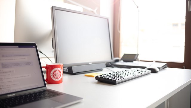 Desk with a laptop and a screen on it