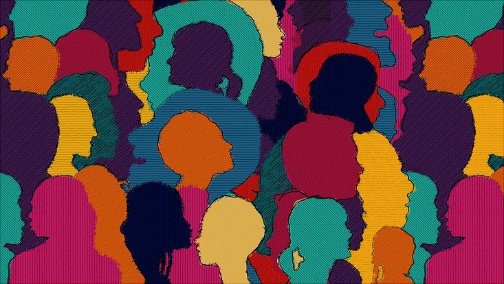 differently colored heads of people in a crowd