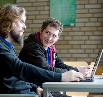 slider5 two males students infront of their laptops