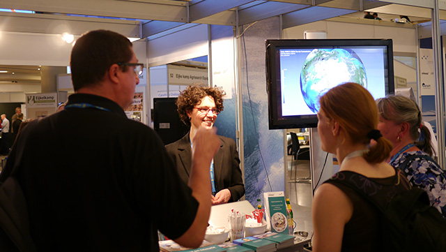 scientists chatting at an information booth
