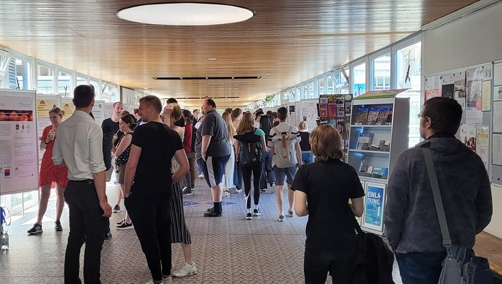 Betrachtung von Postern im Glasgang