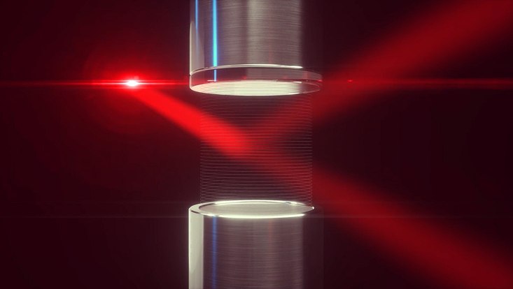 Scientific illustration with a red laser beam that runs between two silver tubes.