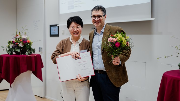evapeters-5006-733x414 Prof. Andrea Cavalleri und Dr. Liuyan Zhao mit Urkunde und Blumen.