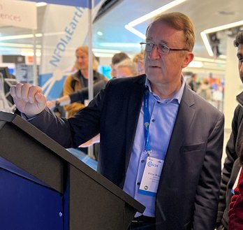 Scientist explaining climate research to interested people at an information stand