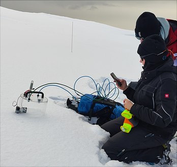 img-20240513-120734-348x329 two scientists measuring methane by closed chamber from snow surface