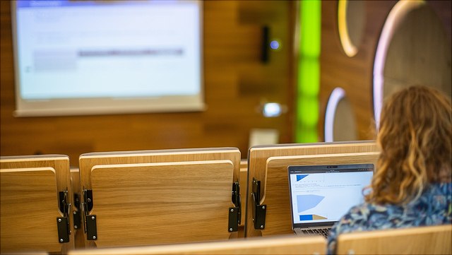 Lecture hall seats and the projector image in the background