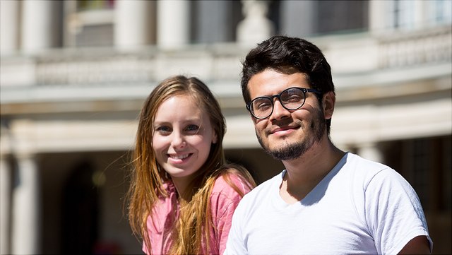 Two guest researchers in front of the main building