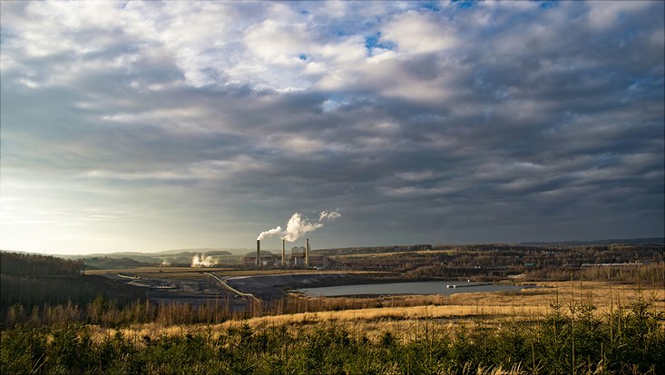A landscape with smoking chimneys.