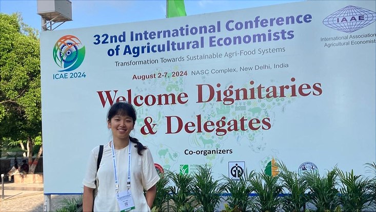 Jihye Jeong in front of the ICAE label