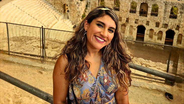 Natalia in front of an antique city panorama