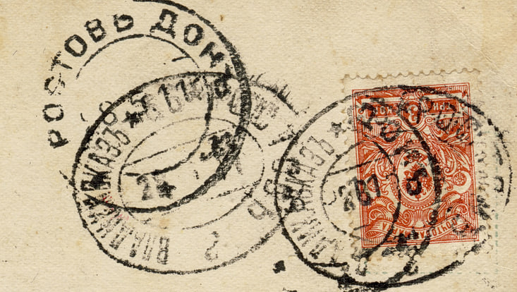 The picture shows an old letter with different symbols and a red stamp on the right side of the letter.