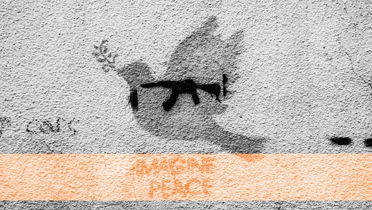 A dove of peace is painted on a wall with a text below stating "Imagine Peace"