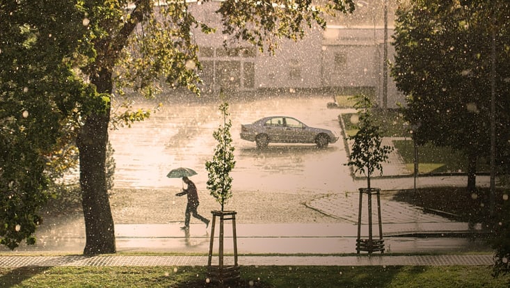 Man walking in extreme rainfall