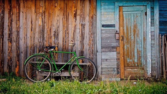 green man's bicycle leaning against old wooden shed