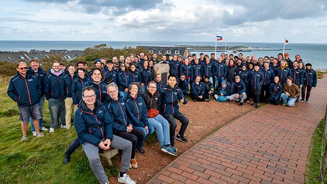 Group of Quantum Universe researchers at the Heisenberg memorial on the island of Helgoland