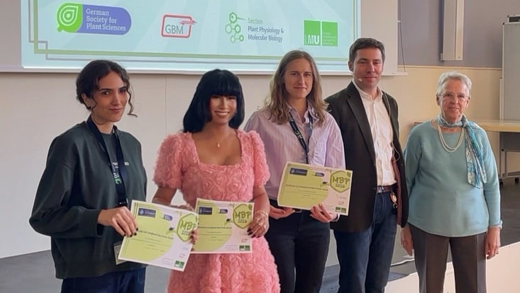 Winners of the best poster prize standing for the camera