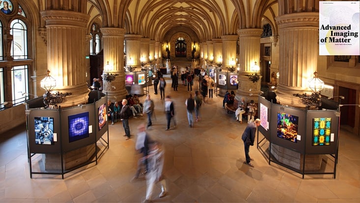 View into a festive hall where scientific images are exhibited