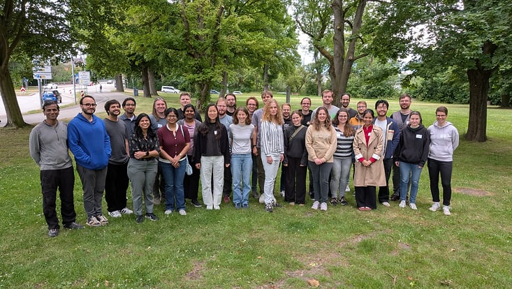 The group picture was taken outside in the green.