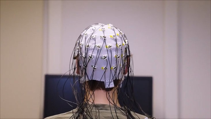 Person mit EEG-Kappe von hinten