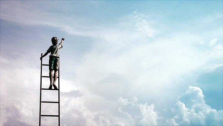 Child on ladder reaching for the sky