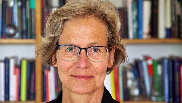 Female with short blonde hair and glasses (Prof. Krasmann)