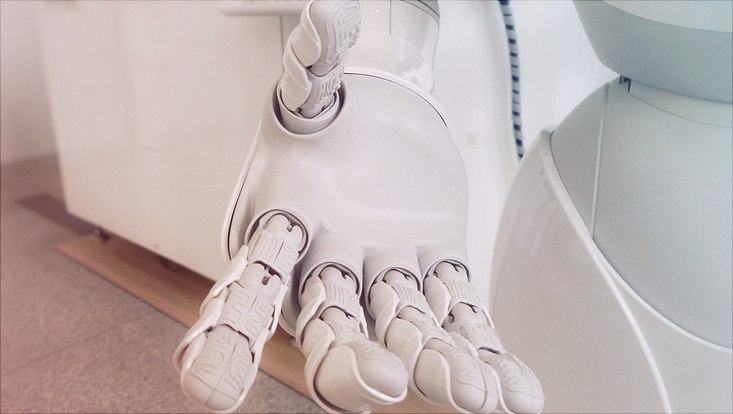 White robot hand reaching out to viewer