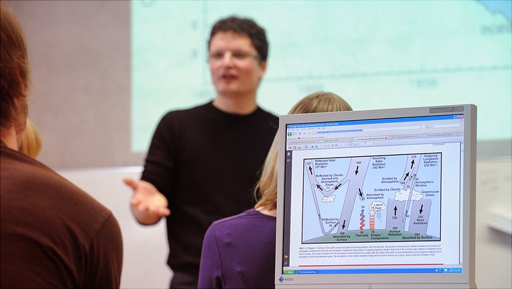 Lecturer talking in background, computer screen with climate graph in foreground