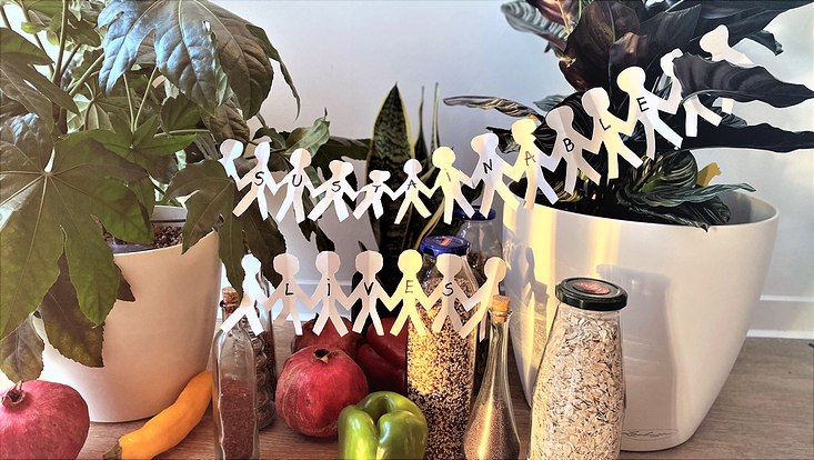 text sustainable lives, in front of different foods and plants