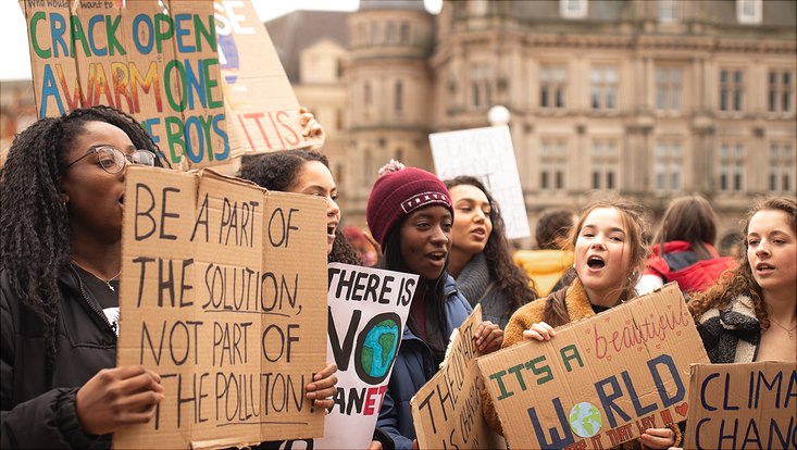 climate protesters with billboards