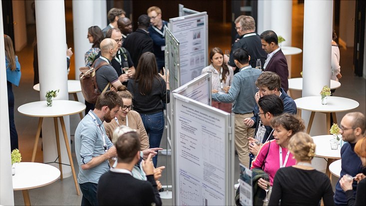 Researchers discussing posters at workshop