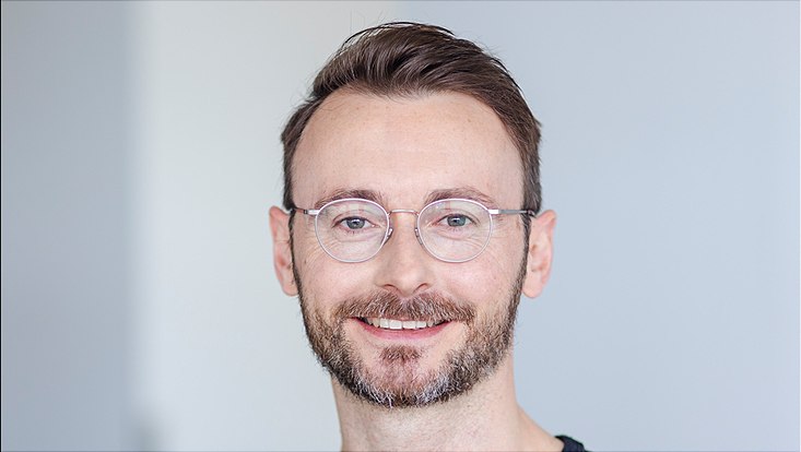 Man with glasses smiling
