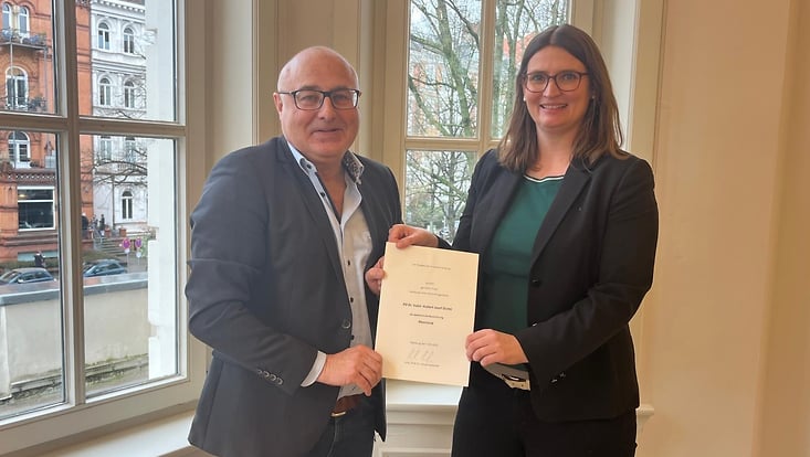 Man receives a certificate from a woman