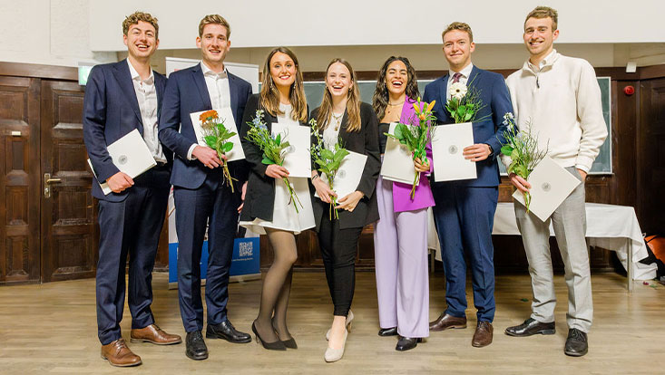 Students with their diplomas on stage