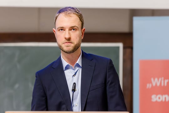 Man speaks into microphone