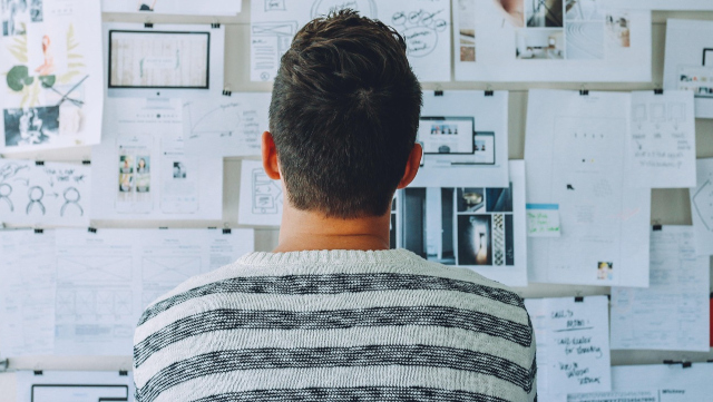 A man looking at a whiteboard