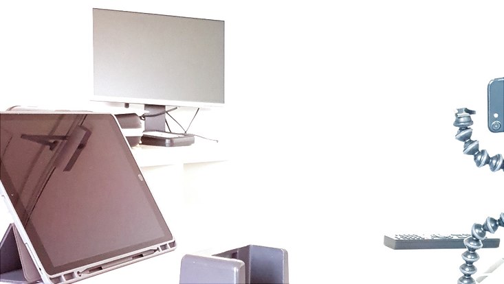 Ein Tablet, ein Bildschirm und Kabel vor weißem Hintergrund