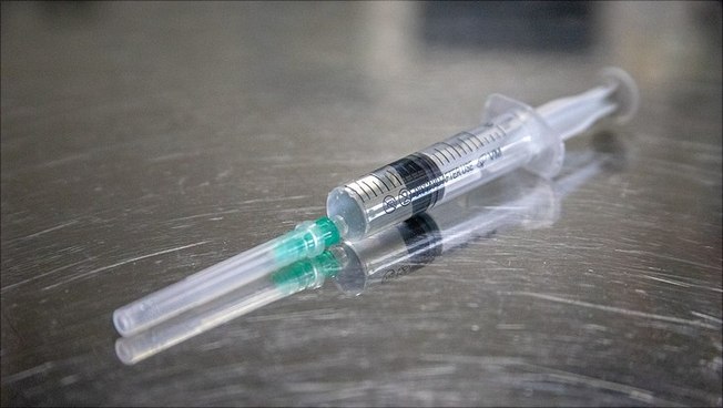 Syringe with vaccine against corona